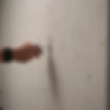 Marking stud locations on a drywall with a pencil